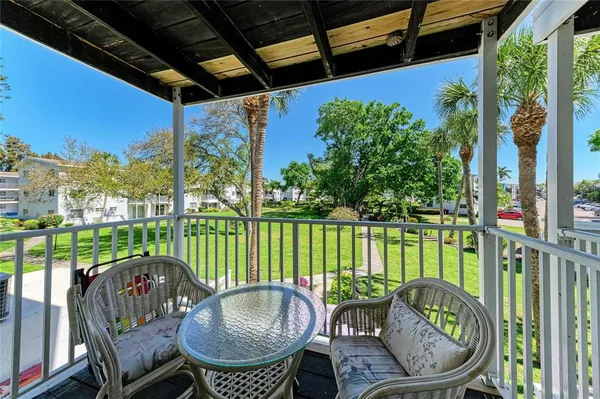 a balcony with table and chairs