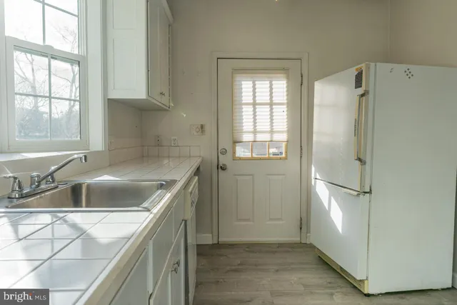 a kitchen with refrigerator and window
