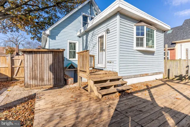 a backyard of a house with barbeque oven table and chairs