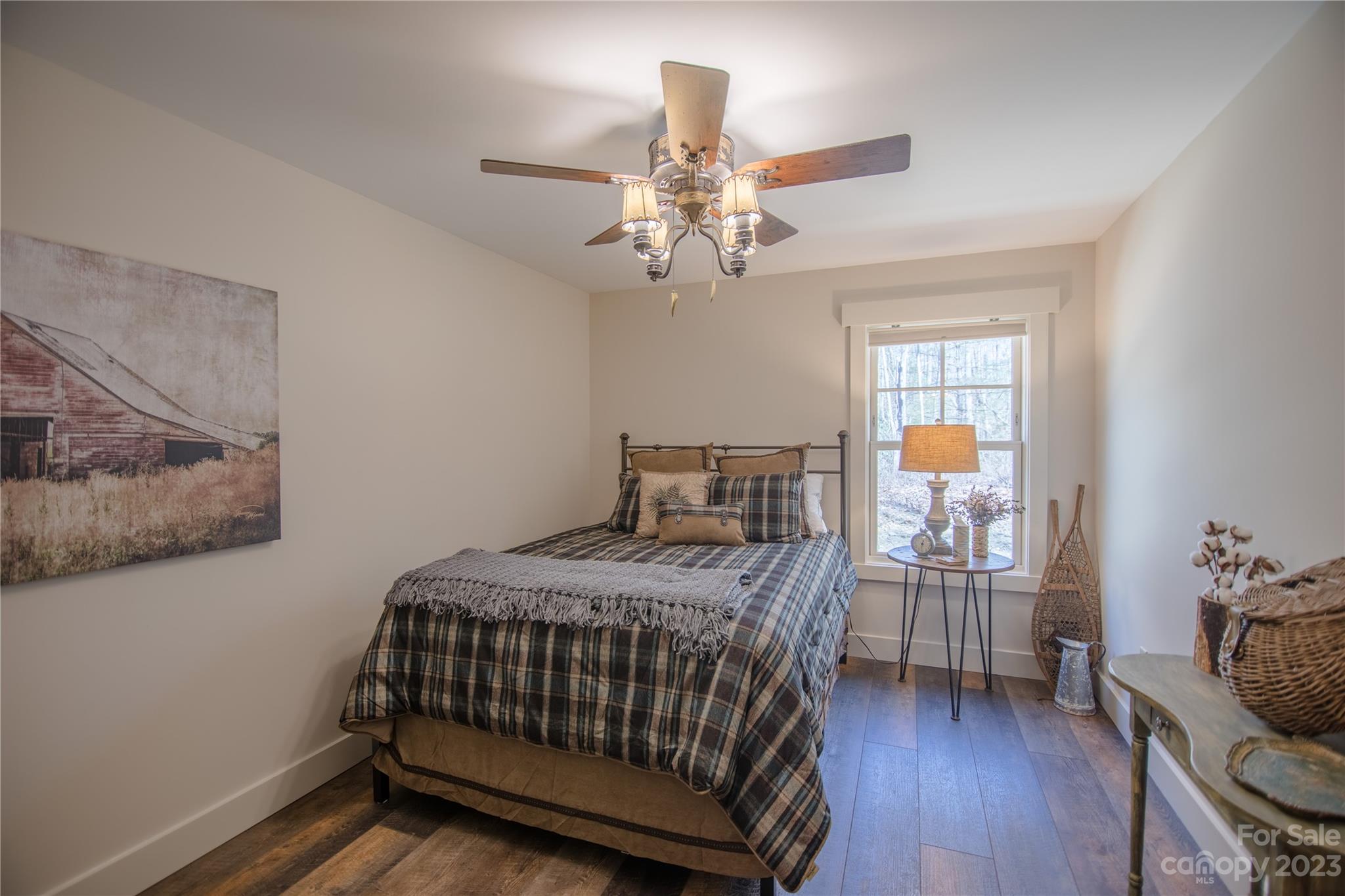 853 Cardinal Road Brevard, NC 28712 - Photo 12 of 28 a bedroom with a bed and wooden floor