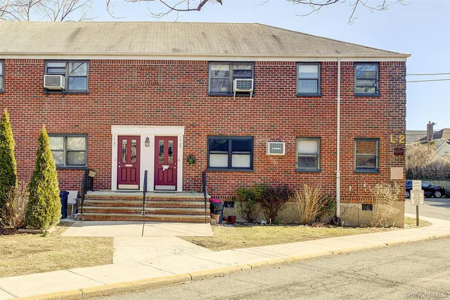 a view of a brick building with many windows