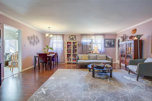 a living room with furniture and a dining table with wooden floor