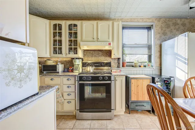 a kitchen with stainless steel appliances granite countertop a stove and a refrigerator