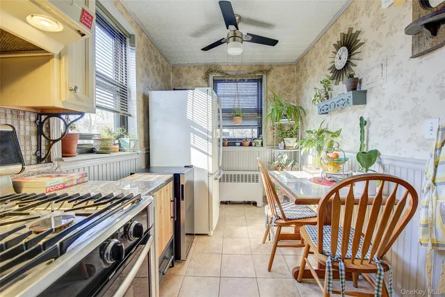a view of a dining room with furniture and a window