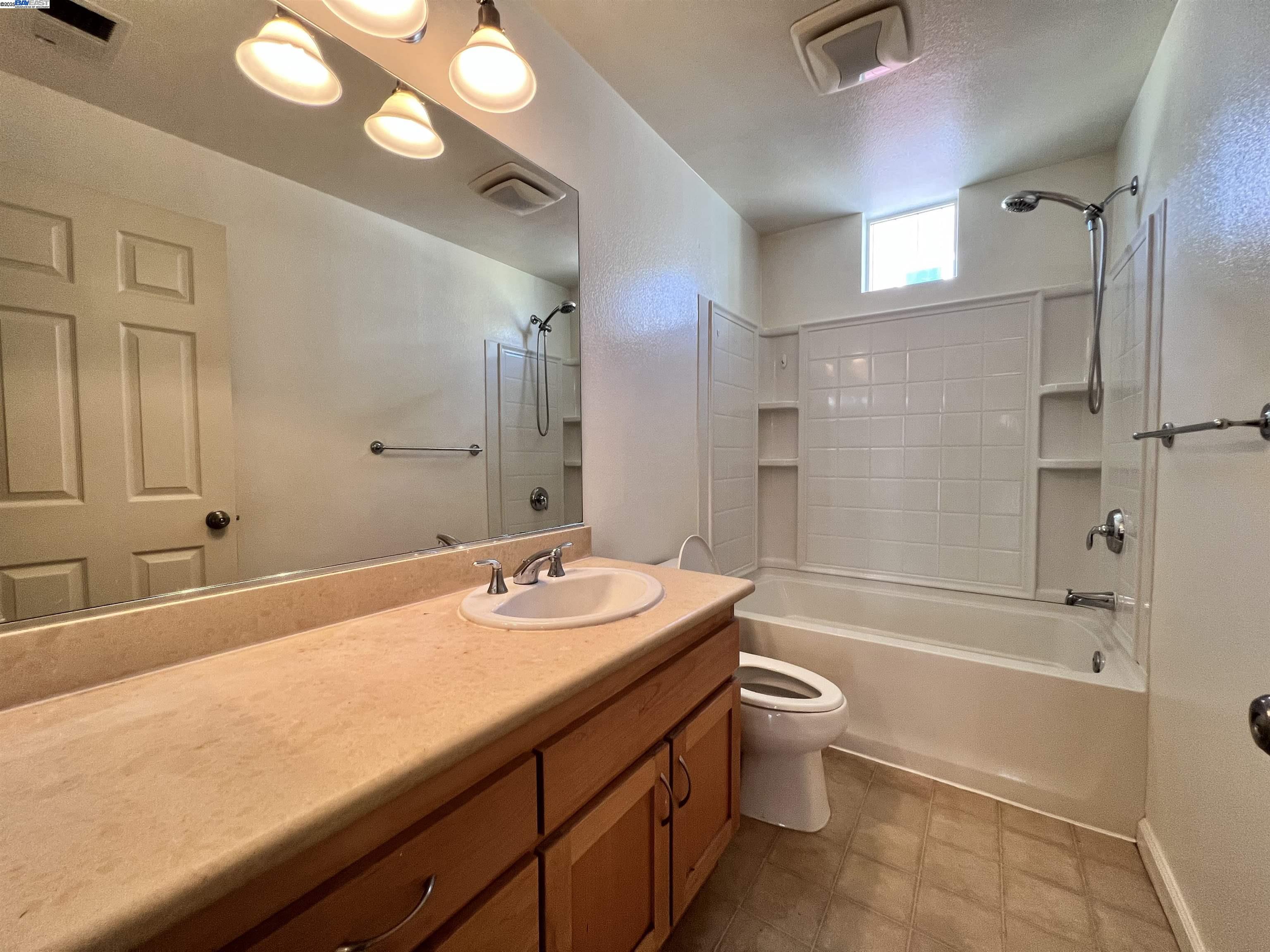 4331 Westerly Common Fremont, CA 94538 - Photo 12 of 24 a bathroom with a granite countertop sink toilet mirror and shower