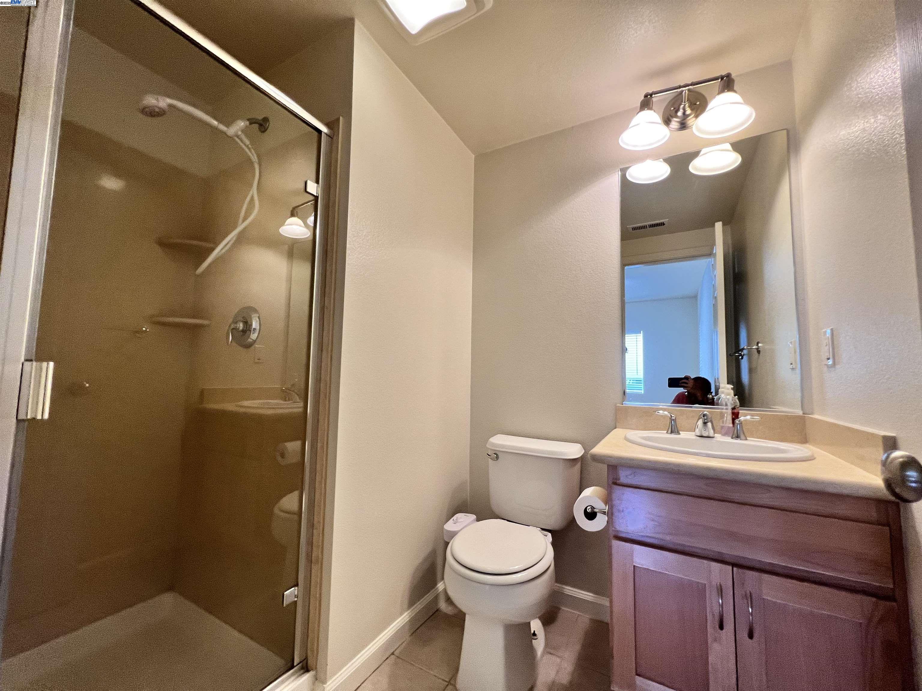 4331 Westerly Common Fremont, CA 94538 - Photo 23 of 24 a bathroom with a sink vanity mirror and toilet