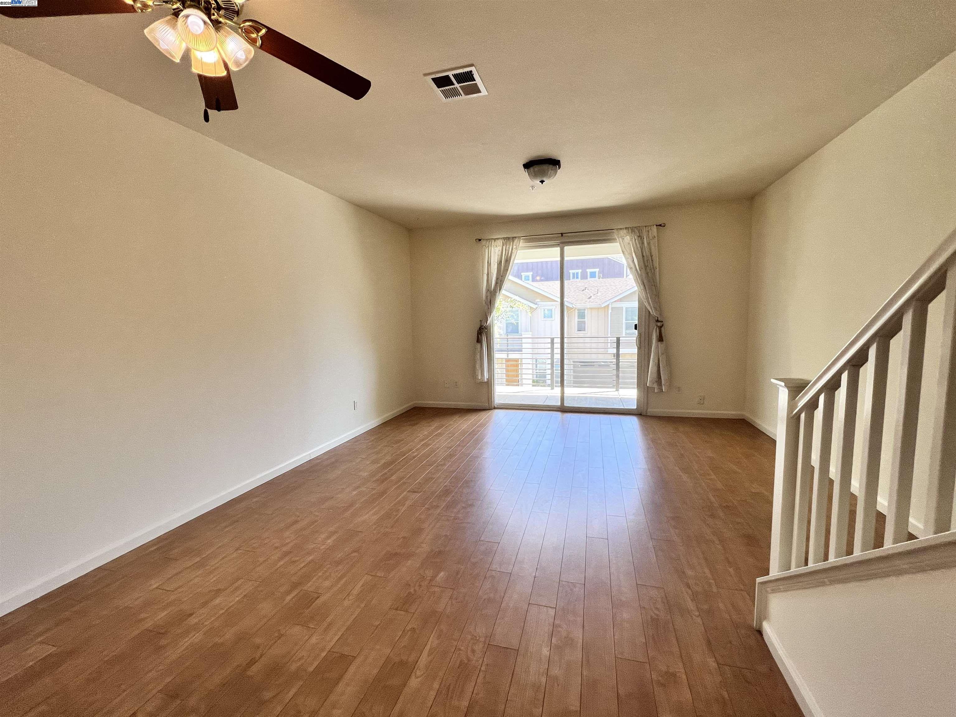 4331 Westerly Common Fremont, CA 94538 - Photo 5 of 24 a view of an empty room with wooden floor and fan