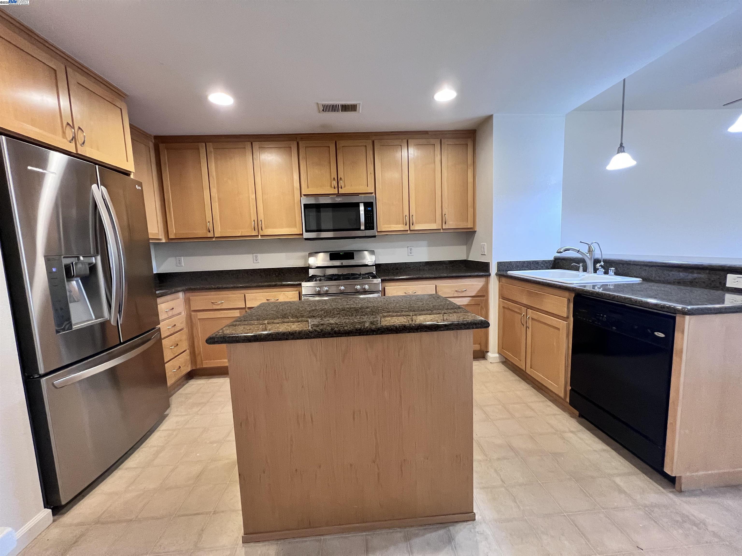 4331 Westerly Common Fremont, CA 94538 - Photo 8 of 24 a kitchen with stainless steel appliances granite countertop a refrigerator a sink a stove a microwave and island