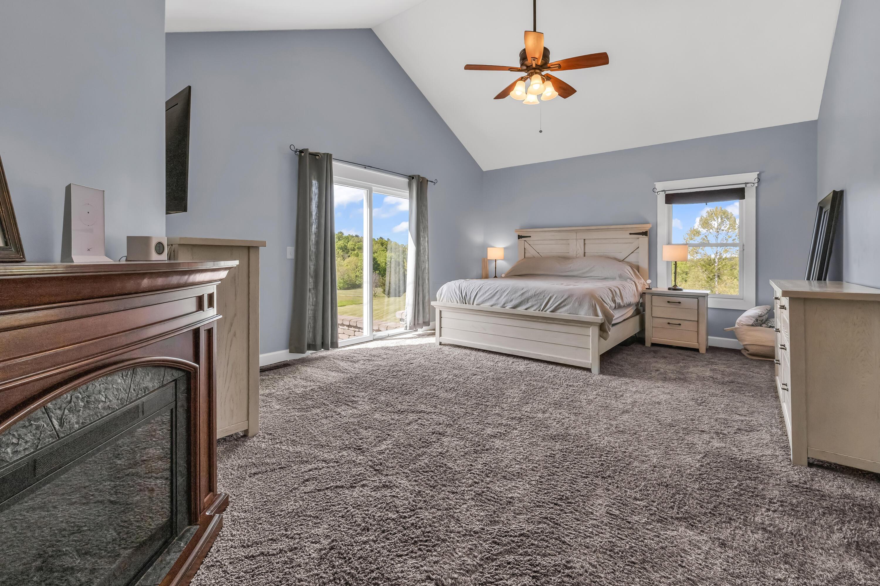 16689 Bailor Road Laurelville, OH 43135 - Photo 11 of 73 • Grey carpet
• Grey painted walls
• Cathedral ceiling
• Lighted ceiling fan
• Sliding doors to patio
• Faux fireplace remains