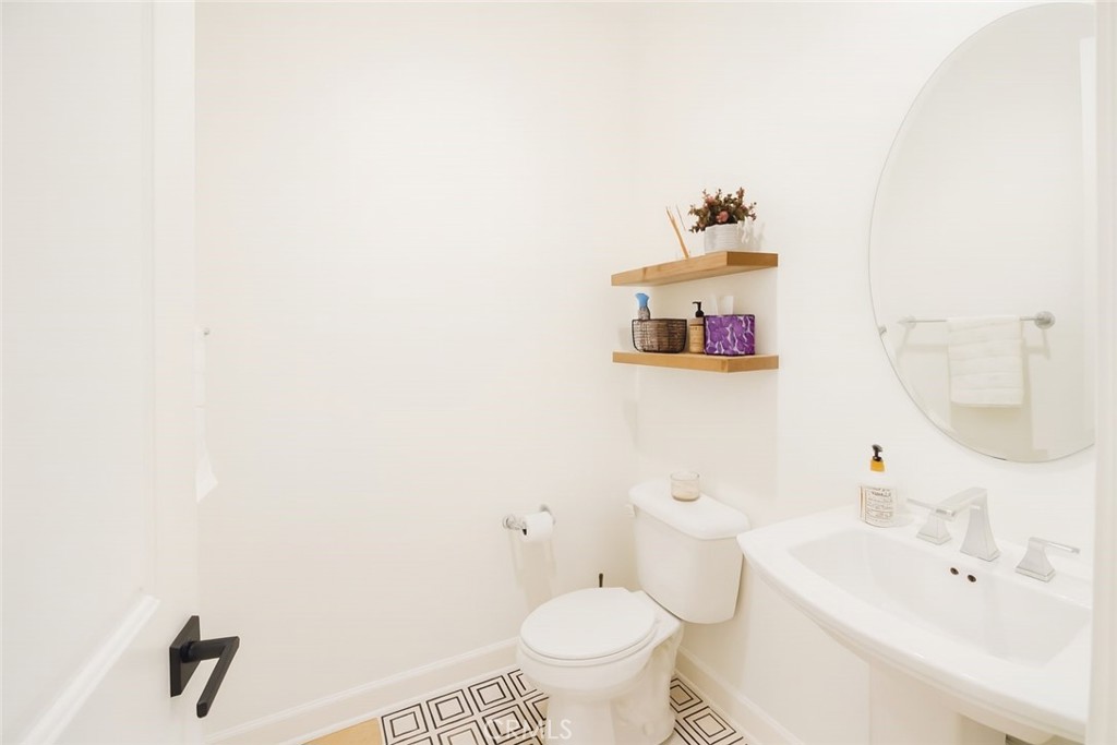 279 Barnes Road Tustin, CA 92782 - Photo 18 of 31 a bathroom with a sink a toilet and a mirror