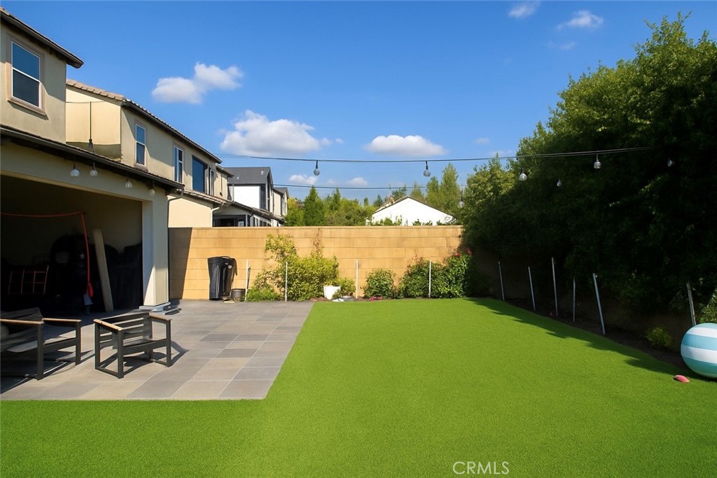 279 Barnes Road Tustin, CA 92782 - Photo 2 of 31 a view of a backyard with plants and a patio