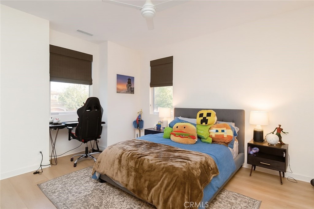 279 Barnes Road Tustin, CA 92782 - Photo 22 of 31 a bedroom with a bed and wooden floor