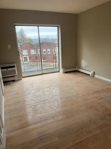 a view of an empty room with glass door