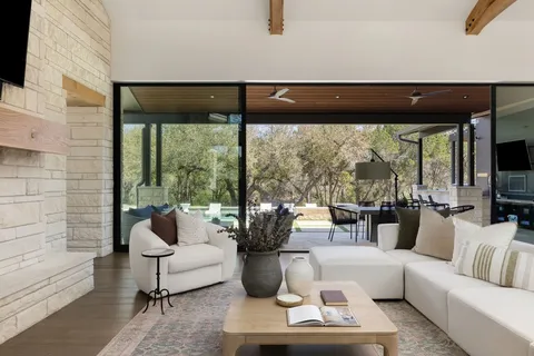 a living room with furniture and a floor to ceiling window