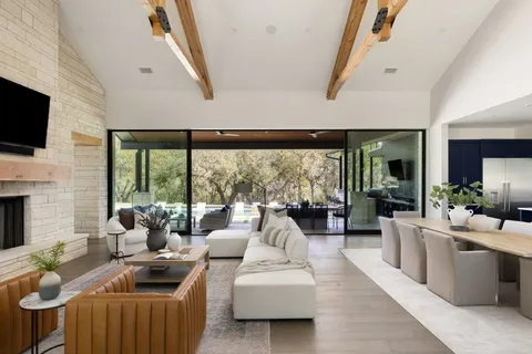 a living room with furniture fireplace and flat screen tv