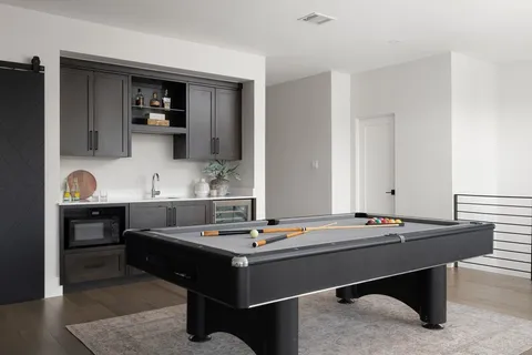 a room with a table chairs and entryway