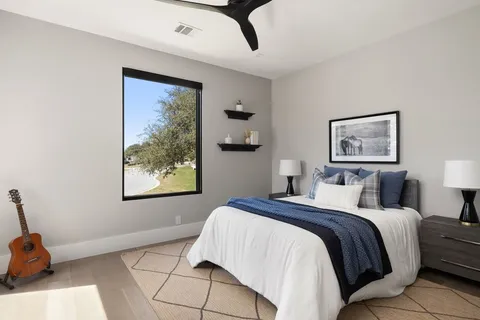 a bedroom with a bed and a painting on the wall