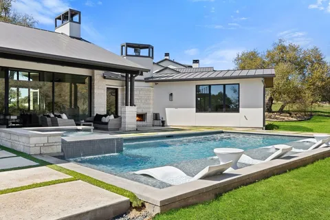 a view of a house with swimming pool and a porch