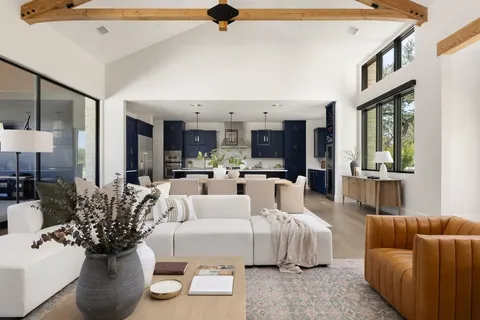 a living room with furniture and a chandelier