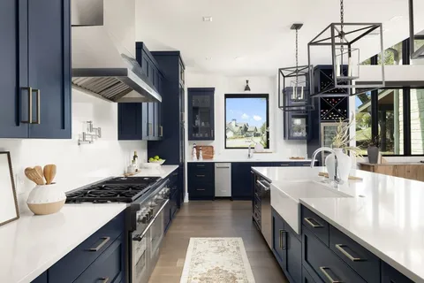 a kitchen with stainless steel appliances granite countertop a sink and stove