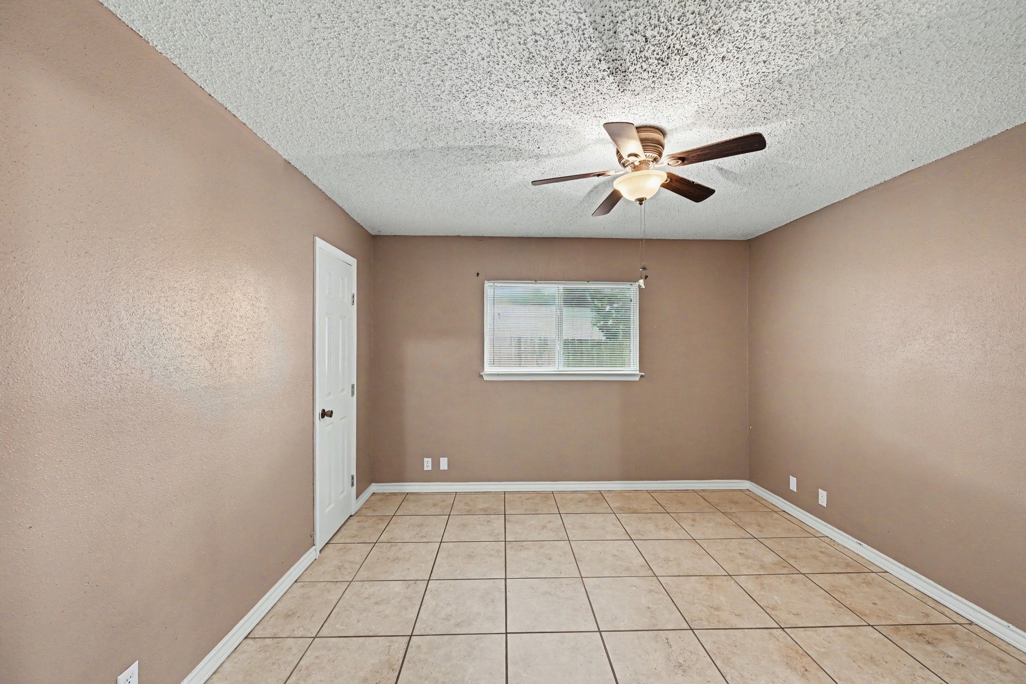 8406 Forest Ridge Drive San Antonio, TX 78239 - Photo 16 of 33 an empty room with chandelier fan and windows