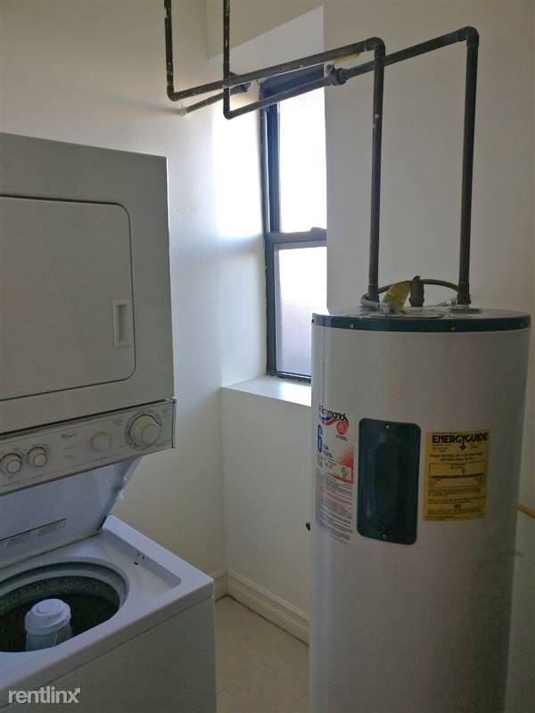 4345 North Sawyer Avenue, Unit A3 Chicago, IL 60618 - Photo 12 of 12 a bathroom with a sink a toilet and a mirror