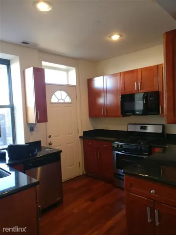 a kitchen with a sink stove and microwave
