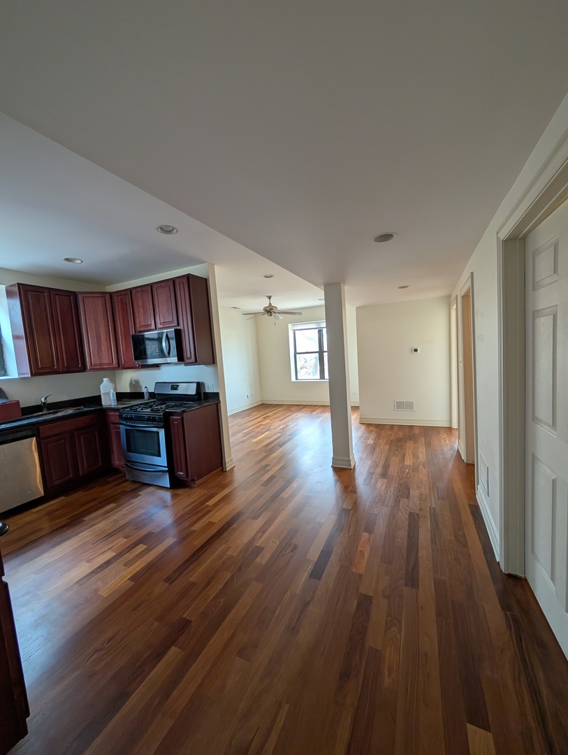 4345 North Sawyer Avenue, Unit A3 Chicago, IL 60618 - Photo 3 of 12 a living room with furniture and wooden floor