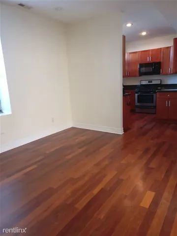 a view of kitchen with wooden floor and a sink