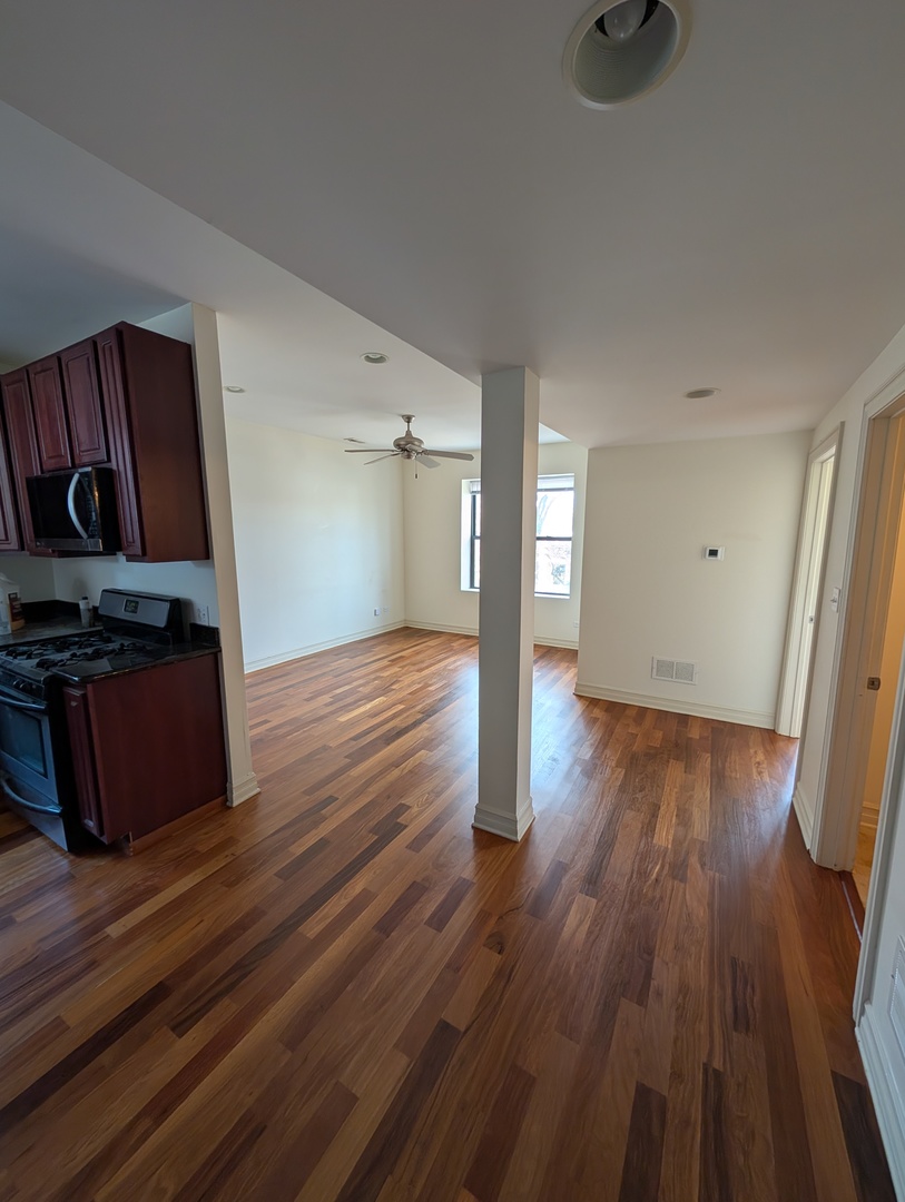 4345 North Sawyer Avenue, Unit A3 Chicago, IL 60618 - Photo 4 of 12 a view of empty room with wooden floor