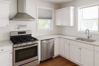 71 Davison Street, Unit 1 Boston, MA 02136 - Photo 2 of 6 a kitchen with white cabinets and appliances