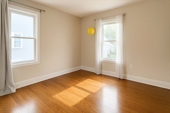 71 Davison Street, Unit 1 Boston, MA 02136 - Photo 4 of 6 a view of an empty room with wooden floor and a window