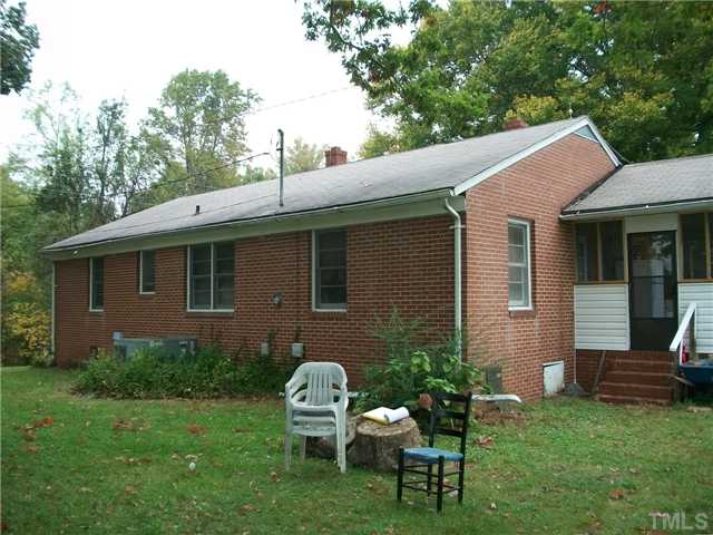 1441 Haywood Bailey Road Roxboro, NC 27574 - Photo 3 of 3 a backyard of a house with table and chairs