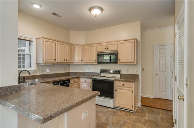 2033 Roderick Circle Franklin, TN 37064 - Photo 5 of 20 Kitchen with breakfast bar and granite counters All appliances remain including washer dryer stack unit