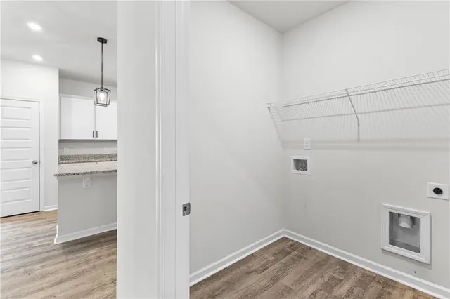 a view of empty room with wooden floor and cabinet