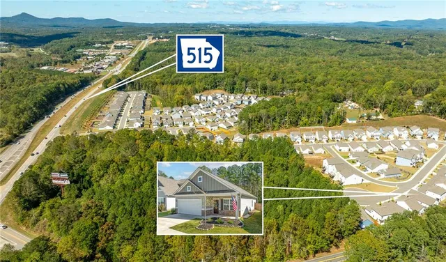 a view of residential houses with outdoor space and river