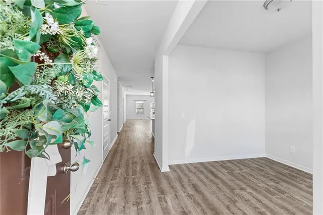 a view of a hallway with wooden floor