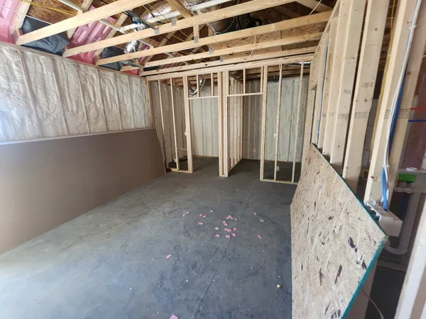 a view of an empty room with wooden walls