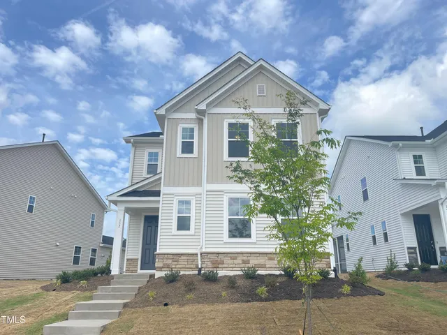 a front view of a house with a yard