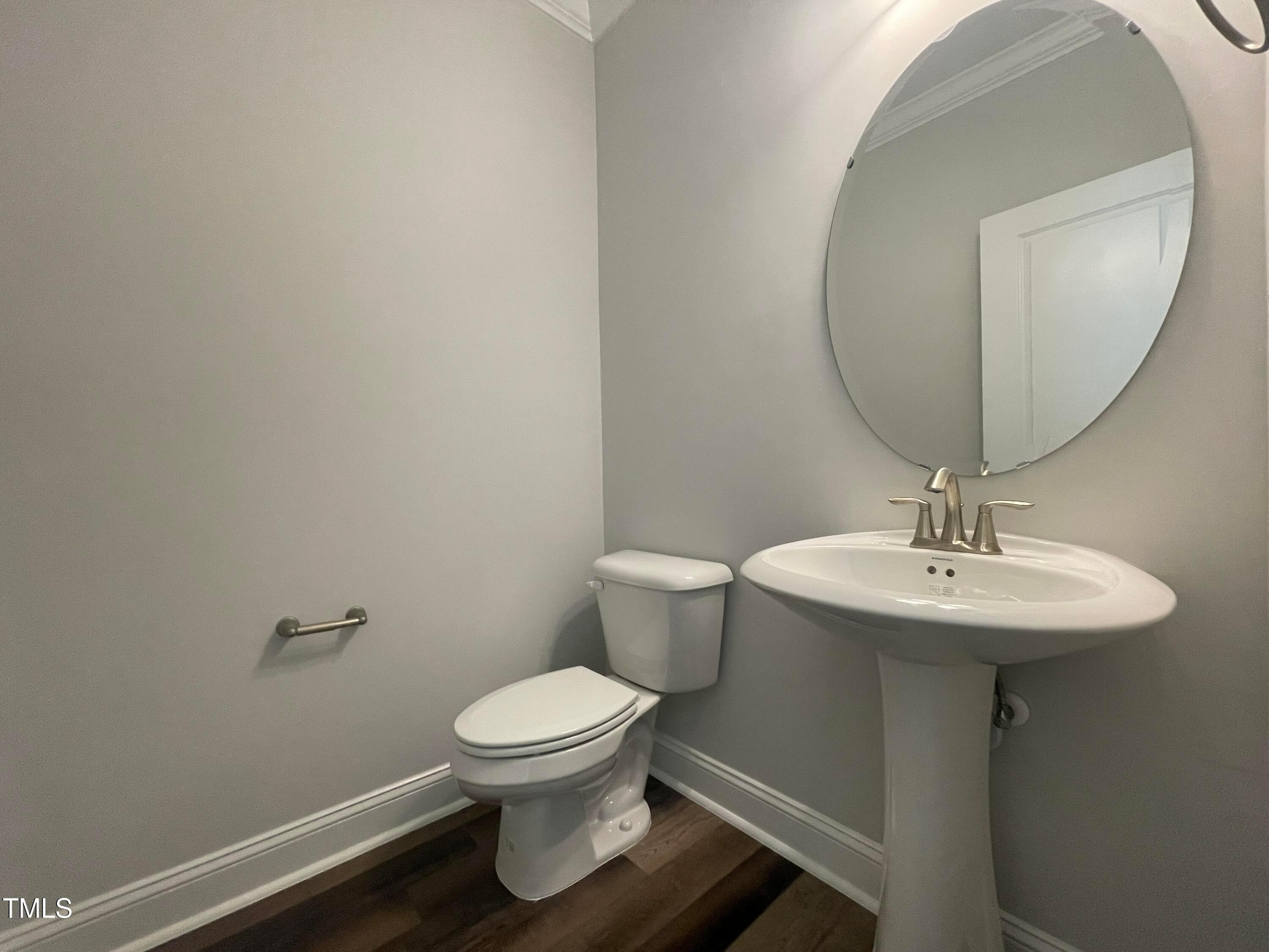 152 Baymouth Lane Raleigh, NC 27610 - Photo 11 of 25 a bathroom with a toilet a sink and mirror