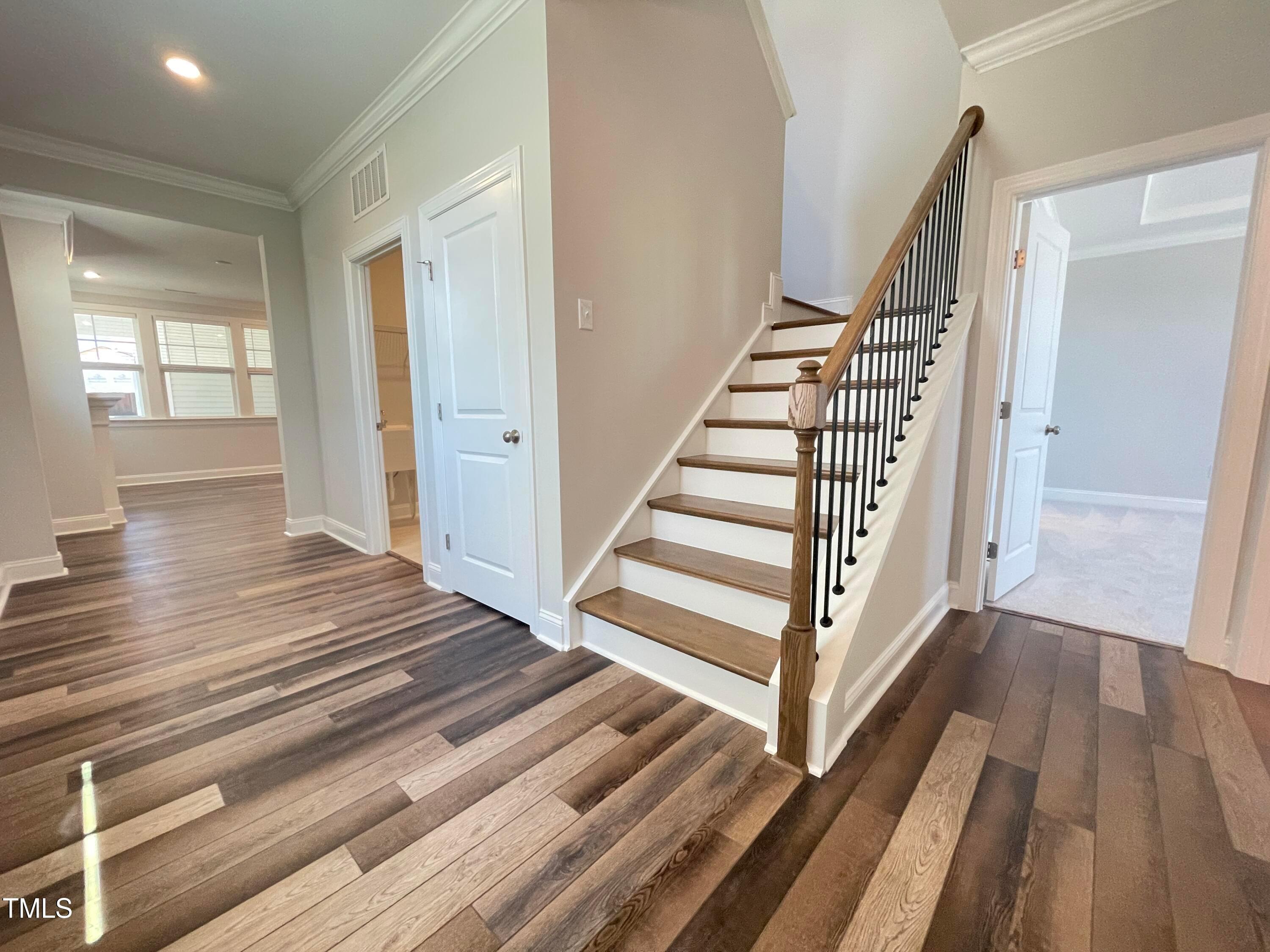 152 Baymouth Lane Raleigh, NC 27610 - Photo 2 of 25 a view of a hallway with wooden floor and stairs