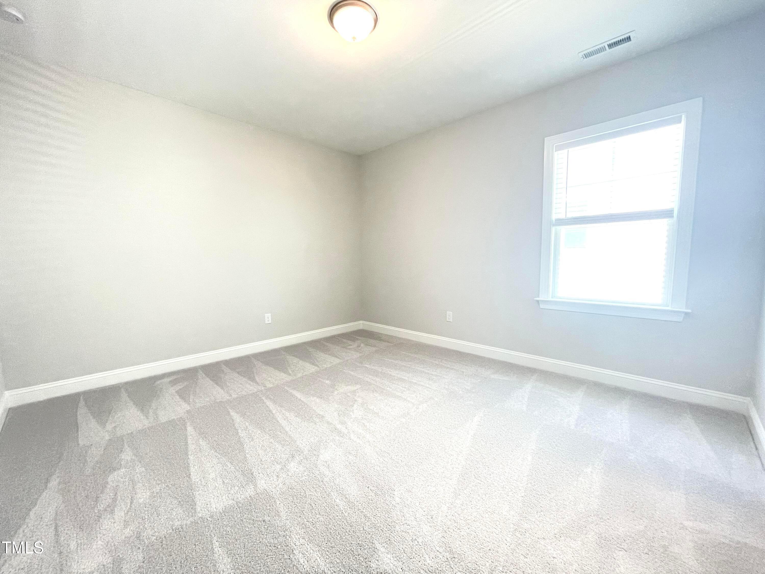 152 Baymouth Lane Raleigh, NC 27610 - Photo 21 of 25 an empty room with a window