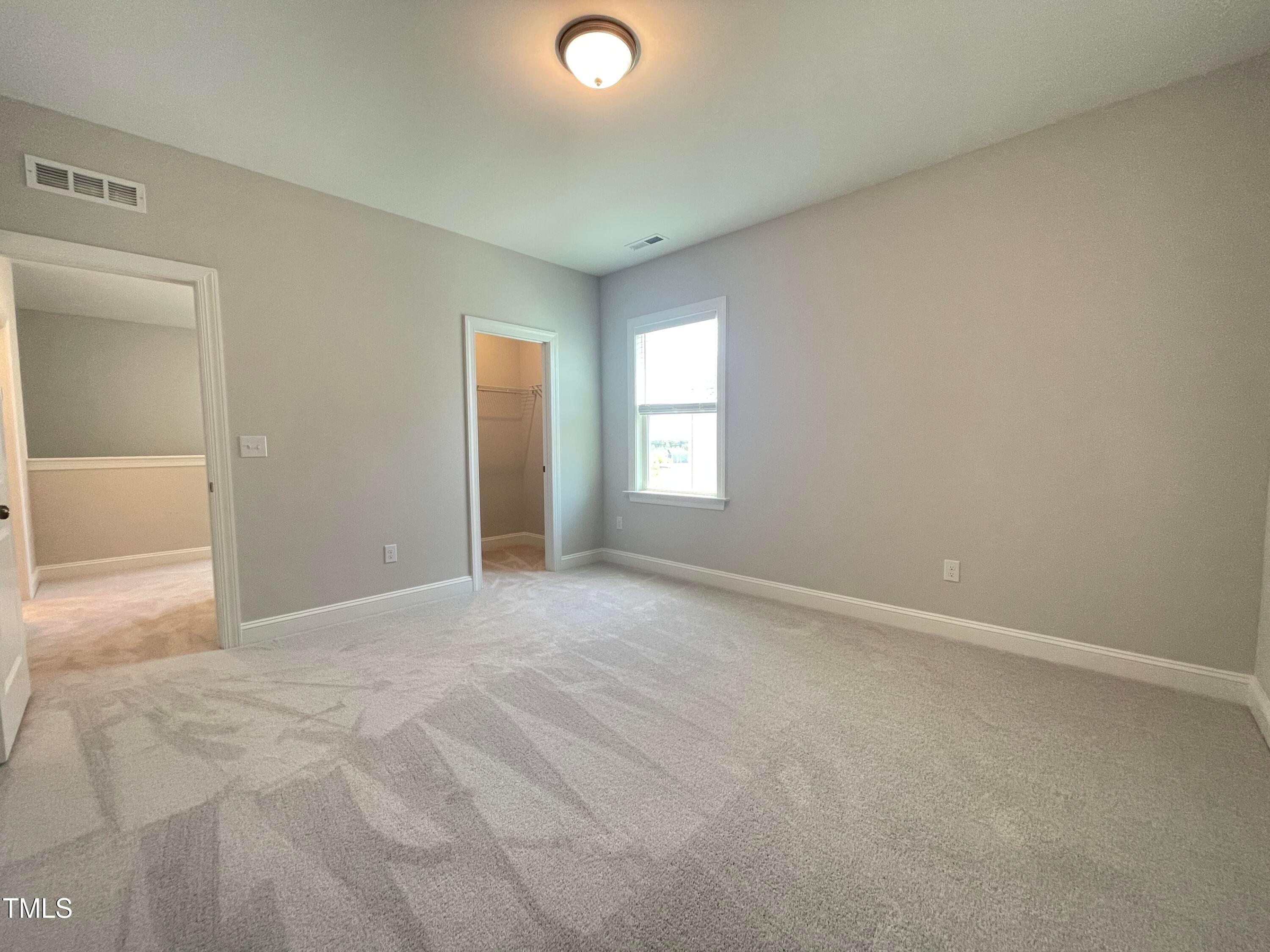 152 Baymouth Lane Raleigh, NC 27610 - Photo 24 of 25 an empty room with windows and closet