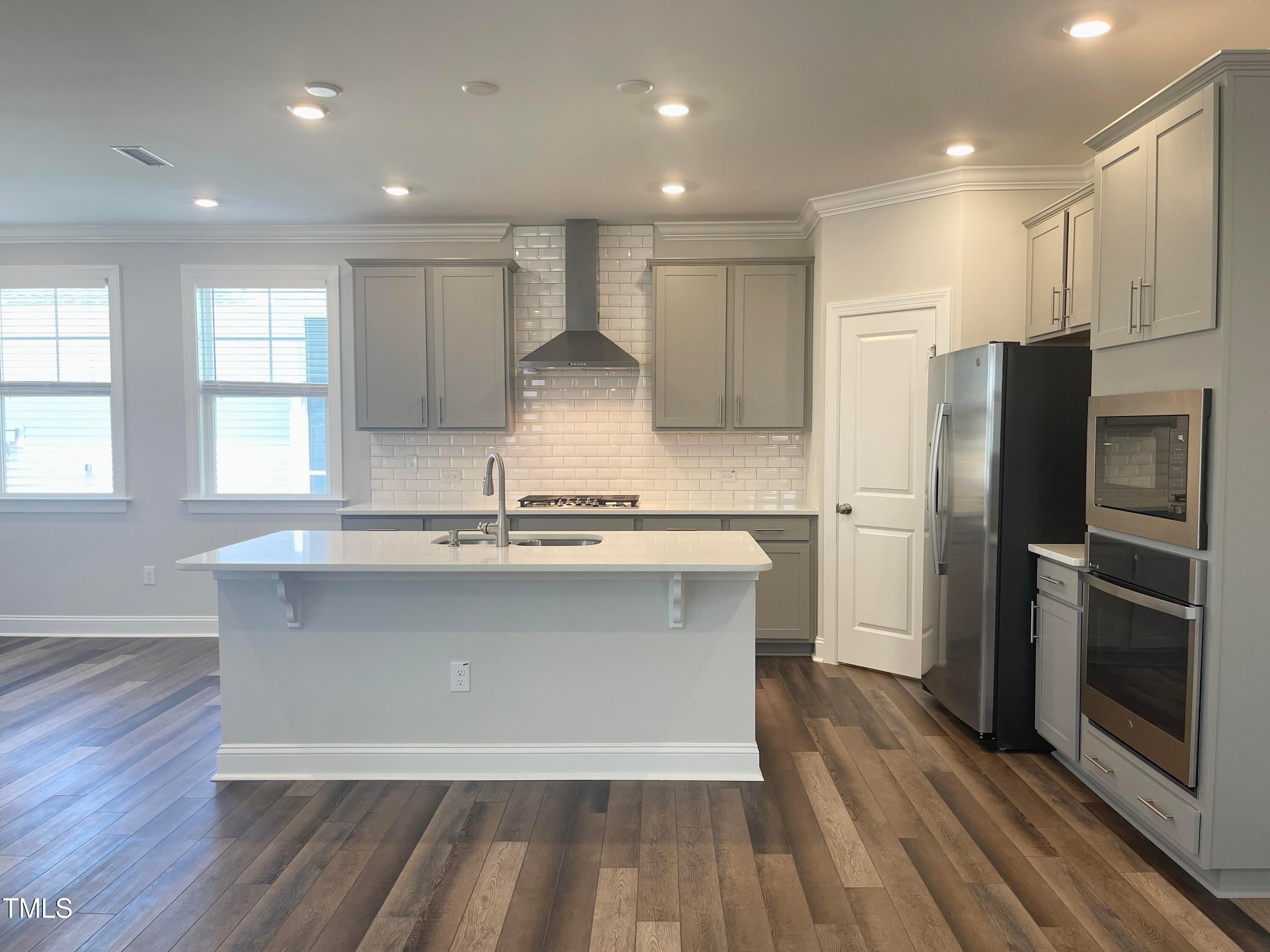 152 Baymouth Lane Raleigh, NC 27610 - Photo 8 of 25 a large kitchen with stainless steel appliances granite countertop a stove a sink and a refrigerator
