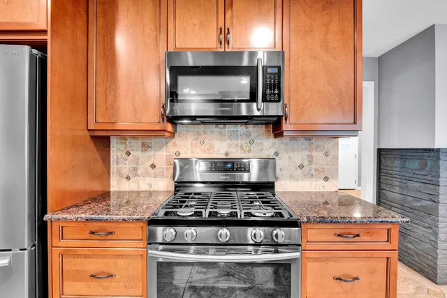 a stove top oven sitting inside of a kitchen