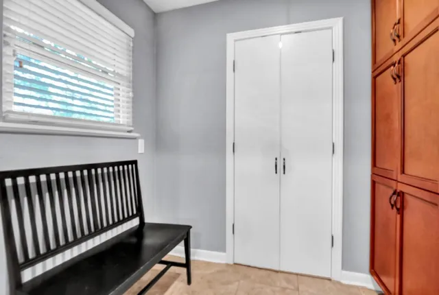 a view of a hallway with wooden floor and a window