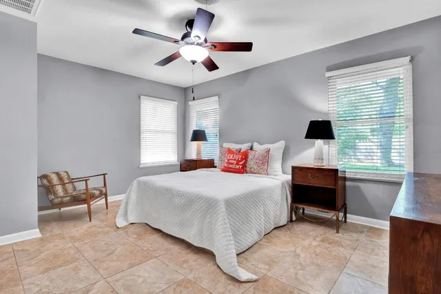 a bedroom with a bed and a desk