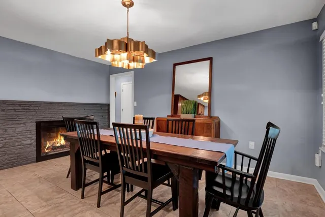 a view of a dining room with furniture wooden floor and chandelier