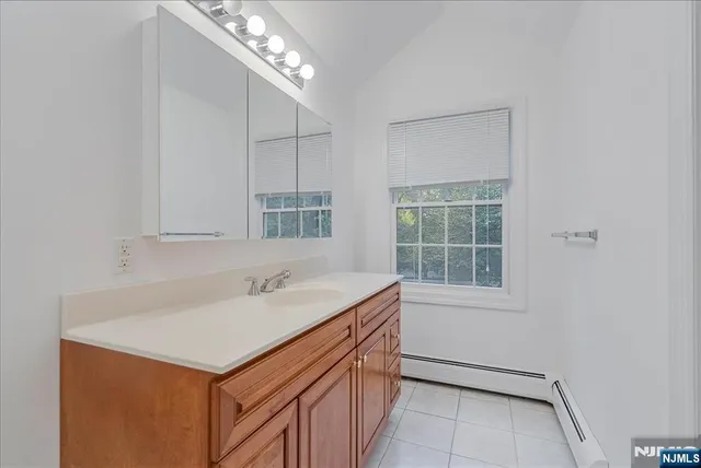 a utility room with a sink cabinets and a window