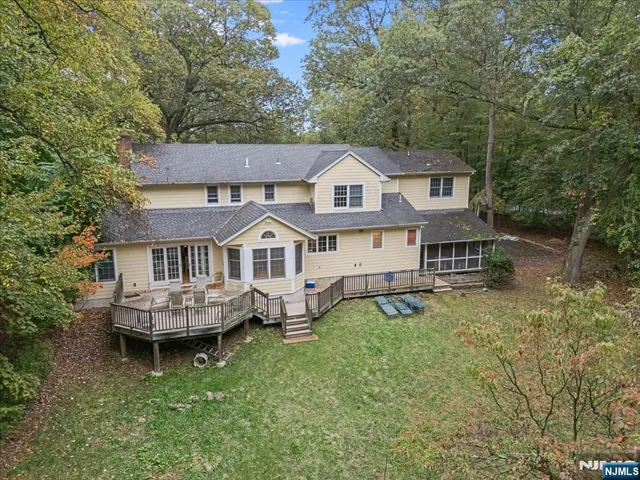 a aerial view of a house with a yard balcony and sitting area
